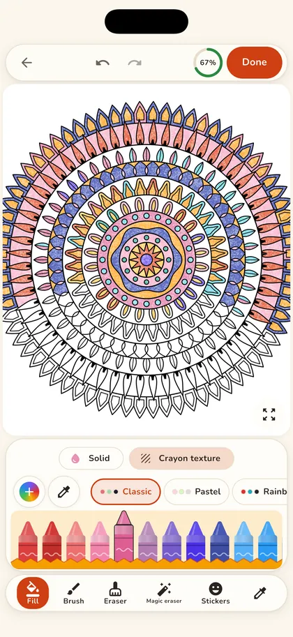 Crayon on iPhone: a mandala half colored with crayon texture, with the crayon box at the bottom